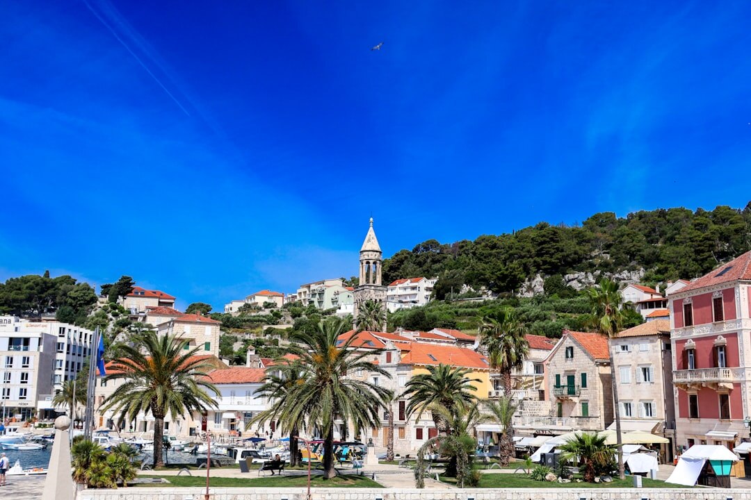 People walking across historic city square in Croatia