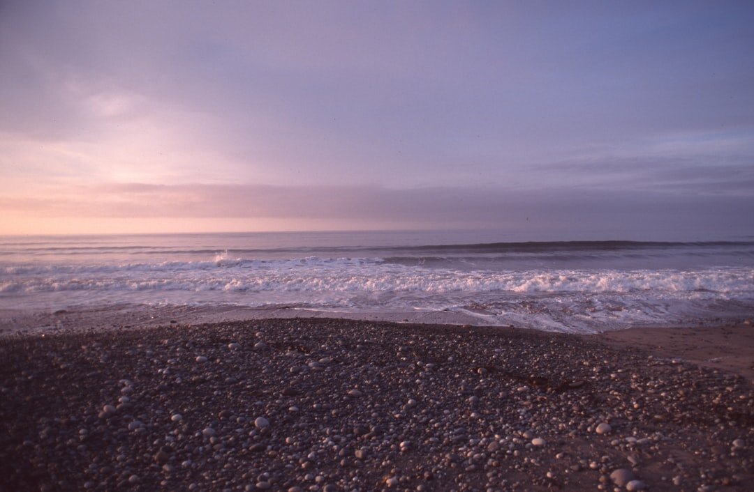 Empty pebble beach in early morning light